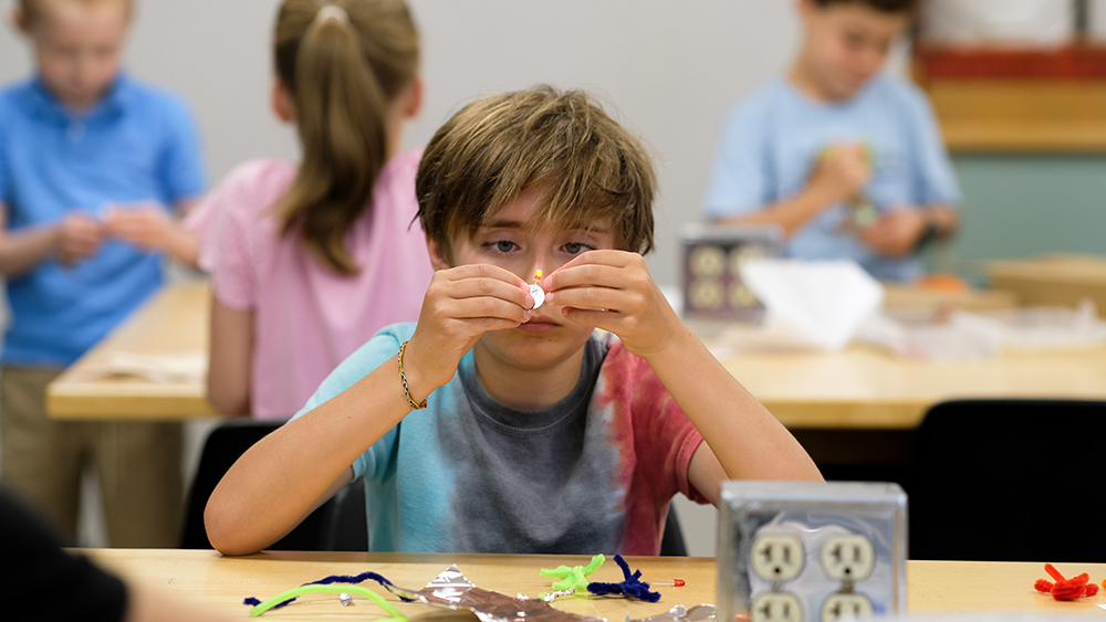 Young student building at a research camp