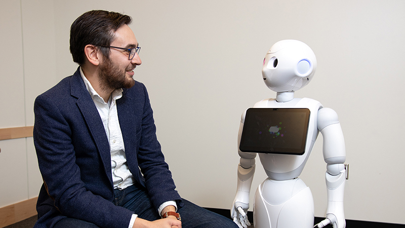 Researcher interacting with a robot